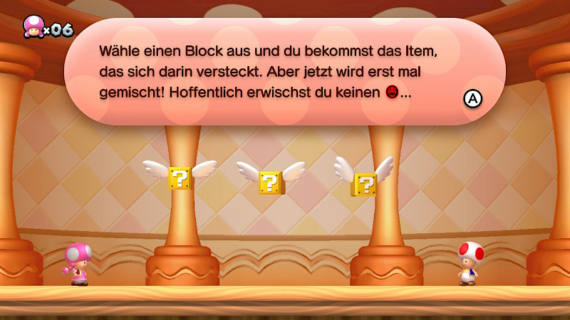 Screenshot von einem Level. Vor Toadette sind 3 gelbe Blöcke mit Fragezeichen und Flügeln. In einer Sprechblase steht: Wähle einen Block aus und du bekommst das Item, das sich darin versteckt. Aber jetzt wird erstmal gemischt! Die Schrift ist gut zu lesen